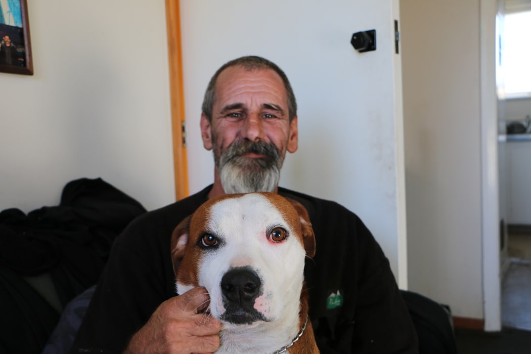 Lenny Holmwood at home with his dog Kūkupa.