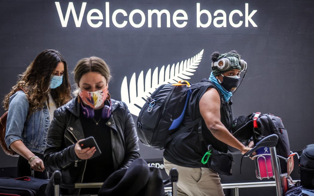 Passengers wearing masks arrive from New Zealand at Sydney International Airport on October 16, 2020.