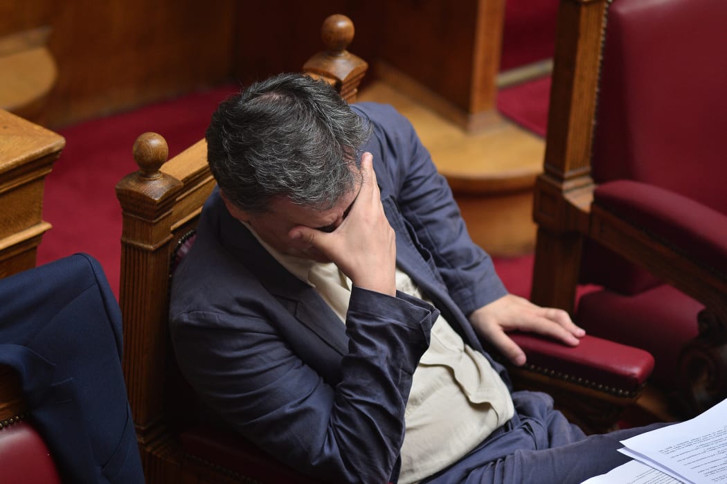 Greek Finance Minister Euclid Tsakalotos gestures during a parliamentary session in Athens on 15 July.