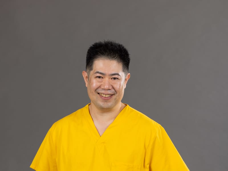 Dr James Jap in yellow scrubs