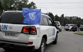 United Nations' vehicles carrying members of the International Atomic Energy Agency (IAEA) inspection mission leave the city of Zaporizhzhia on September 1, 2022, as UN inspectors prepare to head to the Russian-held Zaporizhzhia nuclear power plant in southern Ukraine. - UN inspectors vowed to continue their visit to a Russian-held nuclear power plant in southern Ukraine despite an early shelling attack on the town next to the facility. (Photo by Genya SAVILOV / AFP)