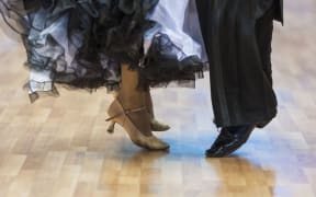 Closeup of legs of the professional dance couple.