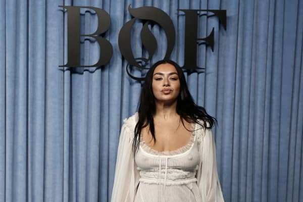 Charli XCX poses upon arrival for The BoF 500 Gala in Paris.