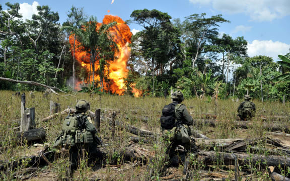 Anti-narcotics police officers blow up a laboratory for processing cocaine base seized from the Revolutionary Armed Forces of Colombia (FARC).