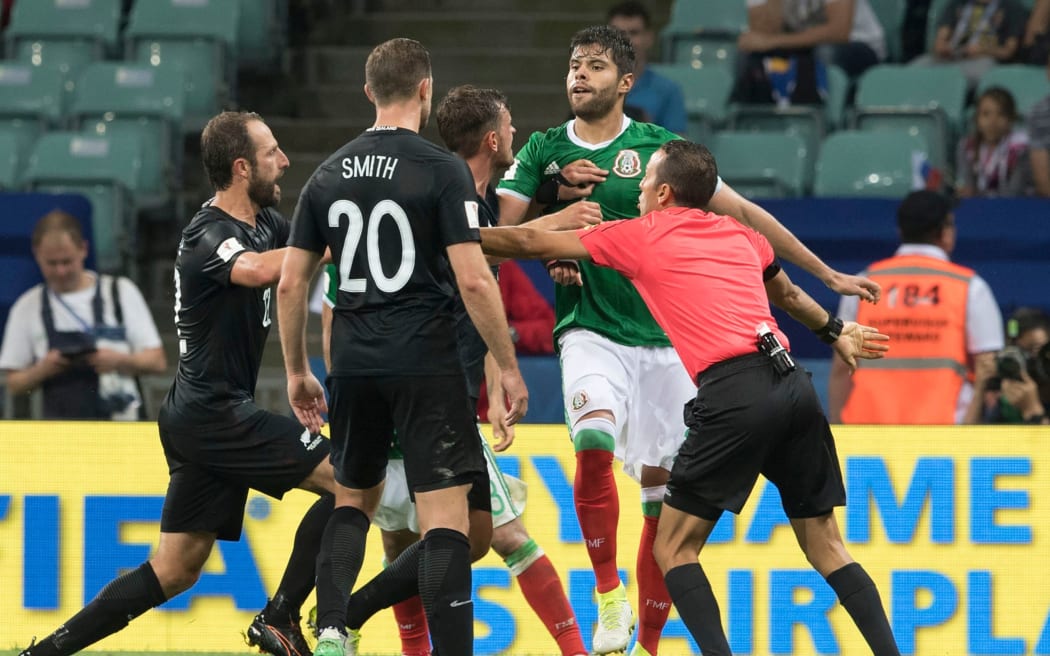 Confrontation between players during the match Mexico vs New Zealand