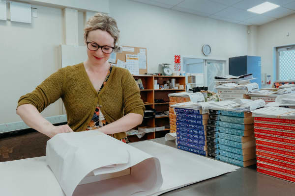 BDS staff member Aimee Bloy wraps books.