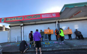 Residents protest outside the site of a proposed bottle shop at 70 Russell Road, Manurewa, August 2025. SINGLE USE LDR