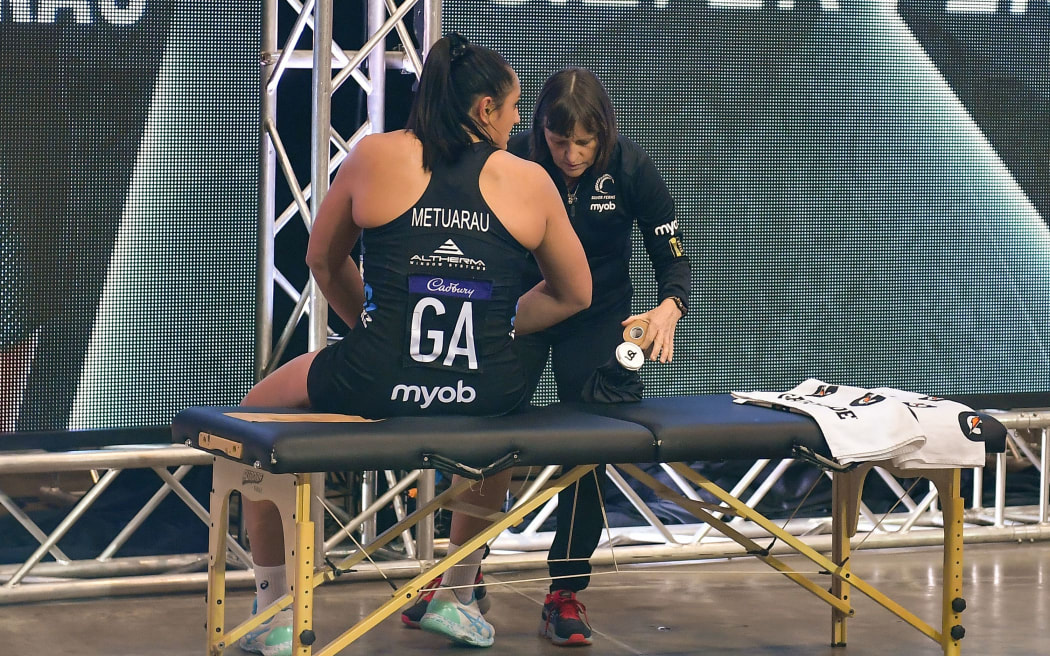 Tiana Metuarau of the Silver Ferns gets medical attention during the 2021 series against England.