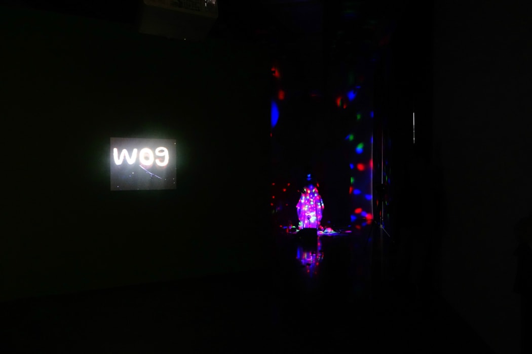Leafa Wilson and Olgar Krause performance art opening, next to Lisa Reihana’s work ‘Wog Features’.