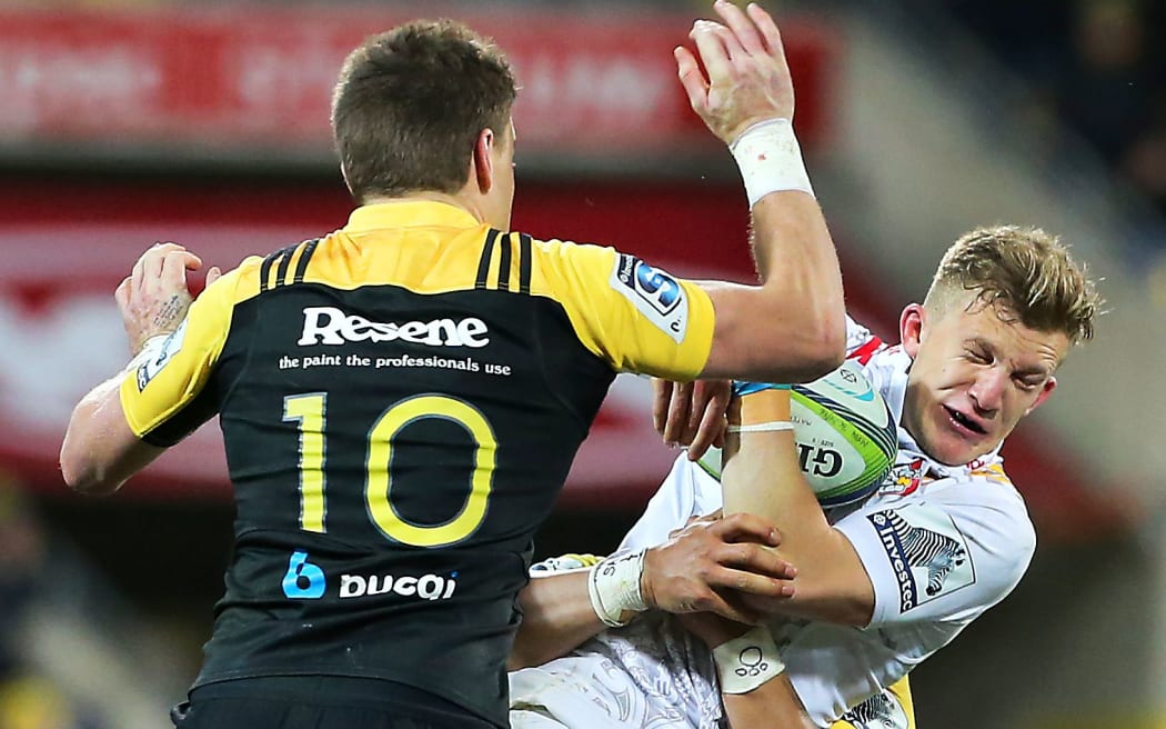 Barrett (left) tackles the Chiefs' Damian McKenzie.