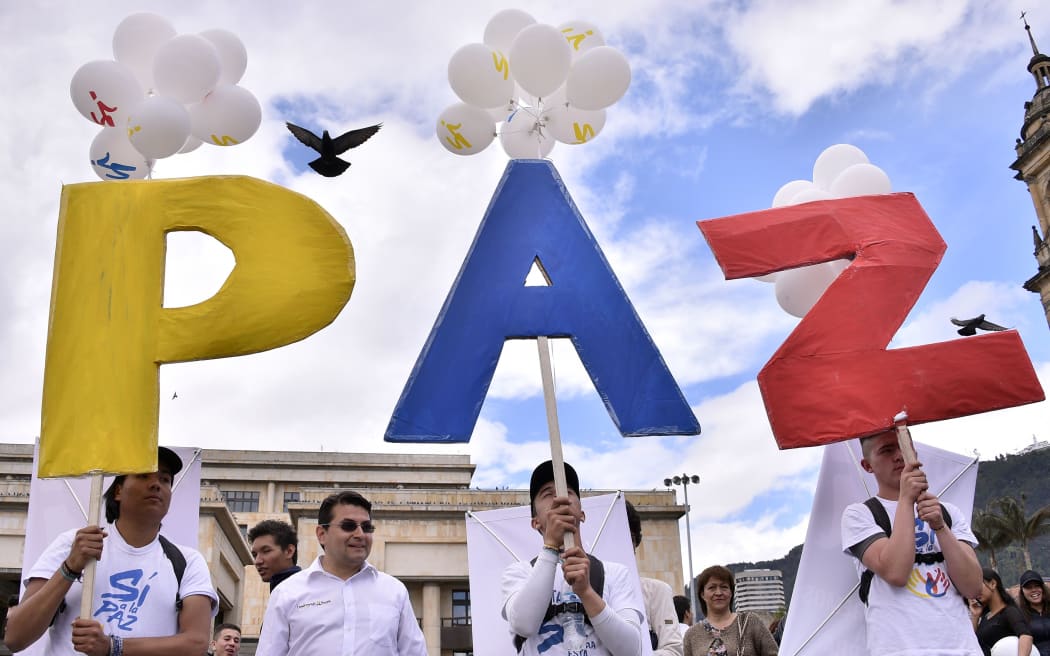 Colombian President Juan Manuel Santos and top rebel leader Timochenko signed peace deal on Monday, ending a 52-year-old conflict that killed more than 220,000 people and forced millions more from their homes.