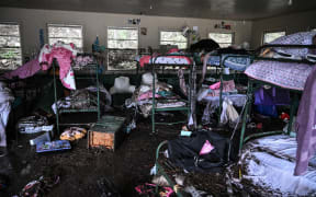 A view inside of a cabin at Camp Mystic, the site of where at least 20 girls went missing after flash flooding in Hunt, Texas, on July 5, 2025. Rescuers were on Saturday searching for more than 20 girls missing from a riverside summer camp in the US state of Texas, after torrential rains caused devastating flooding that killed at least 27 people -- with more rain on the way. "So far, we've evacuated over 850 uninjured people, eight injured people and have recovered 27 deceased fatalities at this time. Of these 27, 18 are adults, nine are children," said Kerr Country Sheriff Larry Leitha on July 5. (Photo by RONALDO SCHEMIDT / AFP)