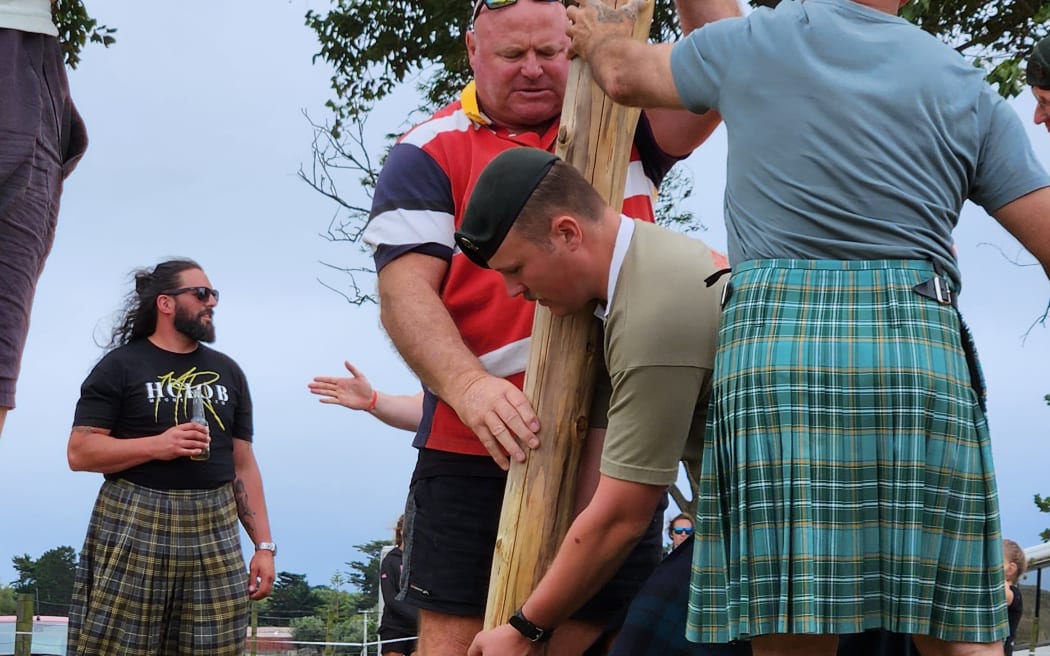 Preparing for the caber toss at the Turakina Highland Games 2024. Competitors are encouraged to wear highland dress.