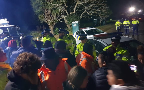 The police line at Ihumatao on Monday evening after more officers were brought in.