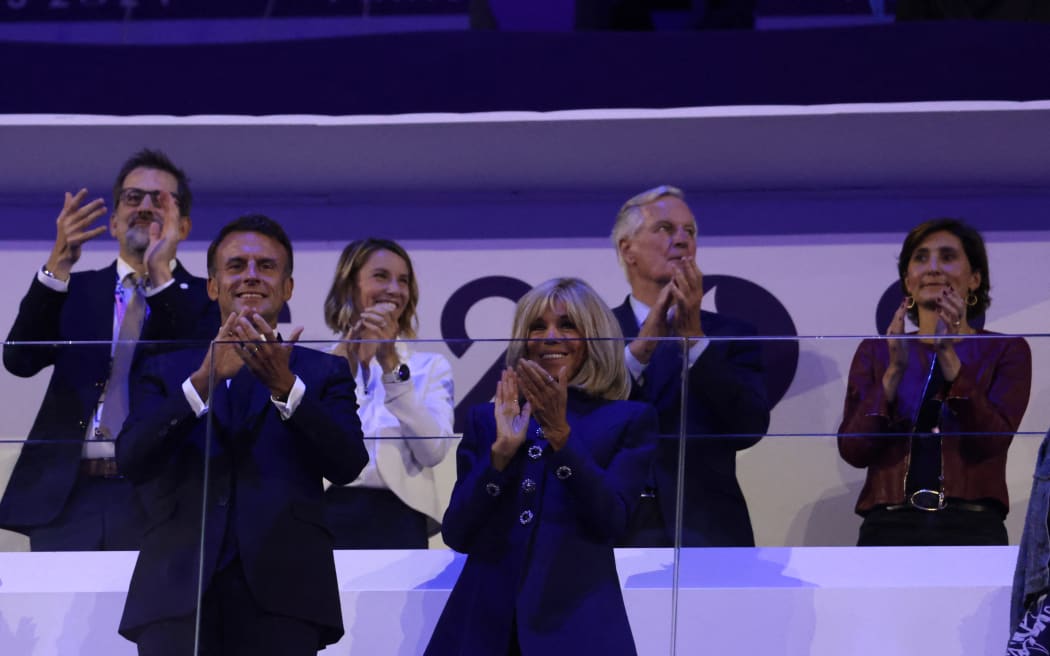 France's President Emmanuel Macron, front left, and wife Brigitte Macron (front R), next to newly appointed French Prime Minister Michel Barnier (back second right) and France's outgoing Minister for Sports and Olympics Amelie Oudea-Castera  (right) attend the Paris 2024 Paralympic Games Closing Ceremony at the Stade de France September 8, 2024.