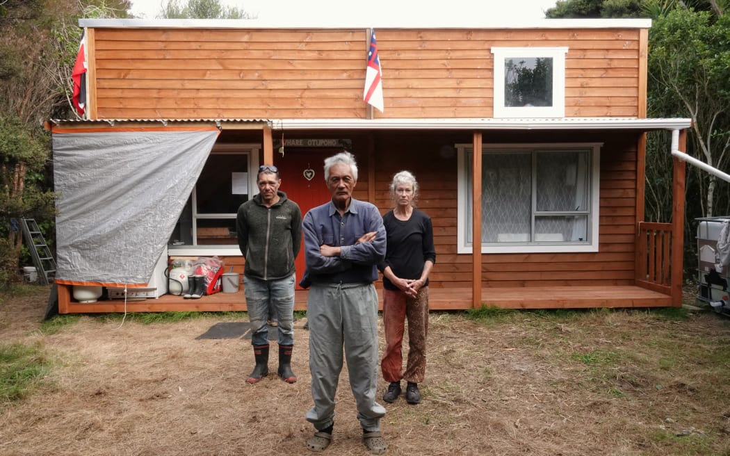 Kaumātua Matutaera Clendon, centre, with nephew John Clendon and partner Bronna Brown at Whare Otupoho, a tiny house built on a DOC reserve on Moturua Island.