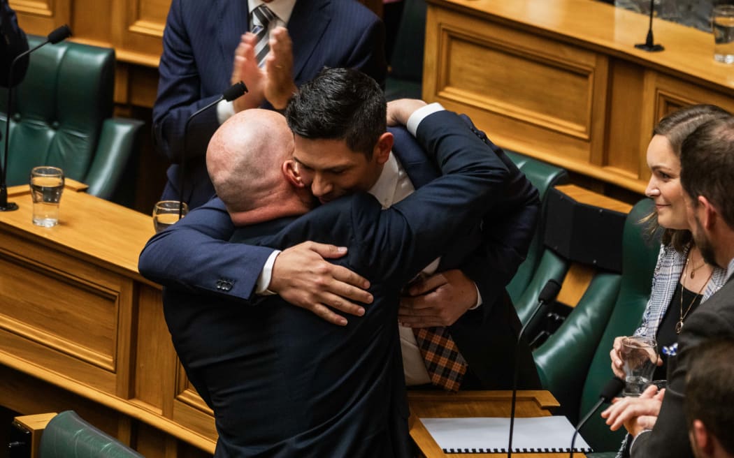 James Meager hugs Prime Minister Christopher Luxon after giving his maiden speech in the House on 6 December, 2023.