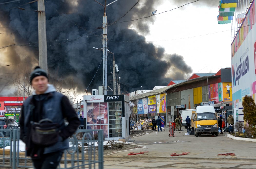 Black smoke rises into the sky from the Barabashovo market - one of the largest markets in the eastern Europe covering an area of more than 75 hectares -  which was reportedly hit by shelling, in Kharkiv on March 17, 2022, amid the ongoing Russia's invasion of Ukraine.