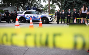 Law enforcement officials are seen as they investigate the home of a suspect arrested in the unsolved Gilgo Beach killings on July 14, 2023 in Massapequa Park, New York. A suspect in the Gilgo Beach killings was arrested in the unsolved case tied to at least 10 sets of human remains that were discovered since 2010 in suburban Long Island. The suspect Rex Heuermann is expected to be arraigned after his arrest Thursday night.