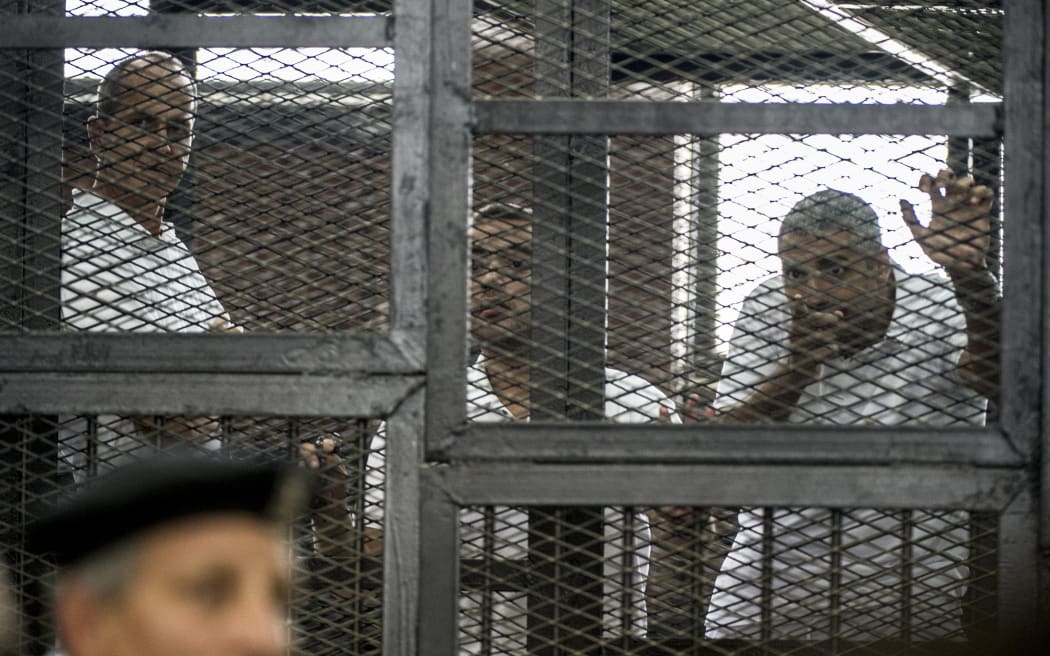 Peter Greste, left, Mohamed Fadel Fahmy and Baher Mohamed at the sentencing.