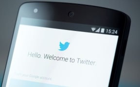Twitter logo on cellphone screen