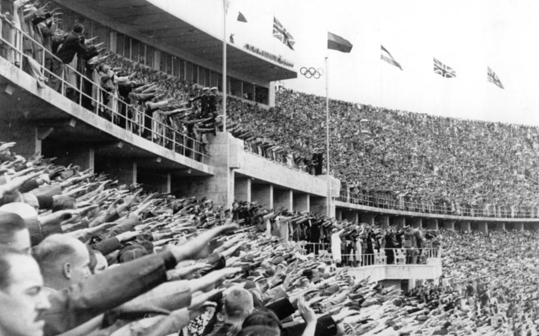 The spectators show the Hitler salute during the opening ceremony of the Summer Olympics on 1 August 1936 in Berlin. (Photo by Schirner Sportfoto / picture alliance / dpa Picture-Alliance via AFP)