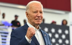 US President Joe Biden pumps his fist after speaking at a campaign event at Renaissance High School in Detroit, Michigan, on 12 July, 2024.