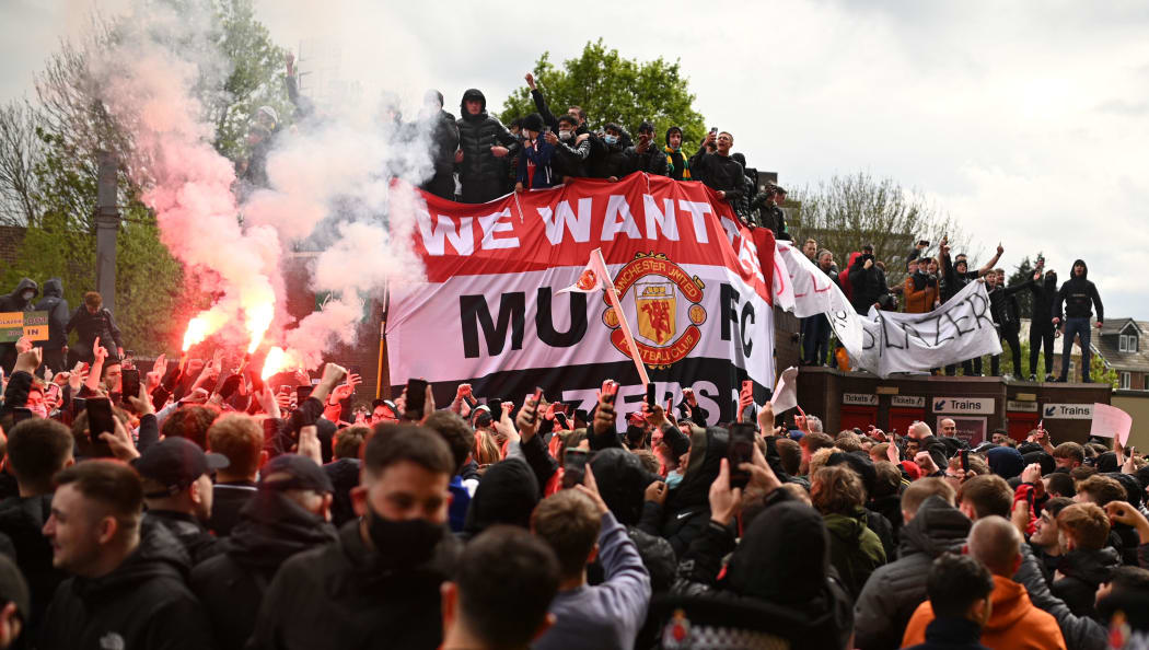 Supporters protest against Manchester United's owners, outside English Premier League club Manchester United's Old Trafford stadium in Manchester, north west England on May 2, 2021, ahead of their English Premier League fixture against Liverpool.