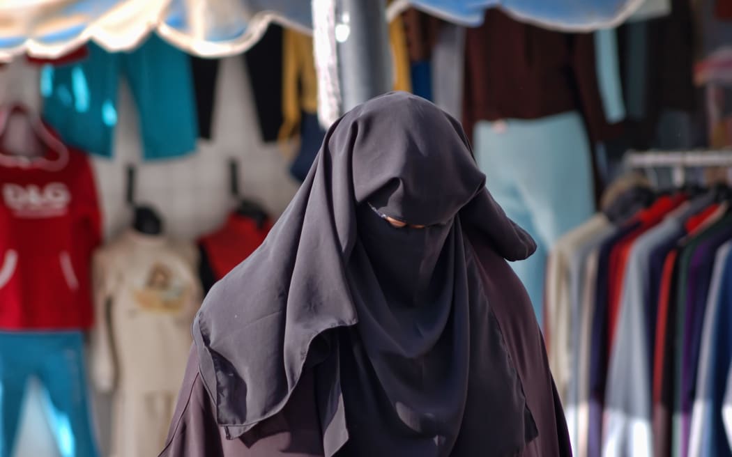 21293717 - woman in a burqa on the streets of egypt