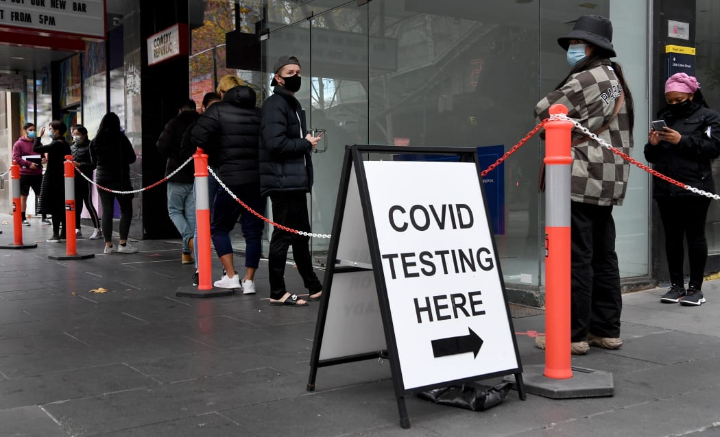 People queue at a Covid-19 testing station in Melbourne on 25 May 2021 as the city recorded five new coronavirus cases in the community.