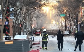 Nashville Fire Department staff on a street damaged after an explosion in Nashville, Tennessee on 25 December 2020.