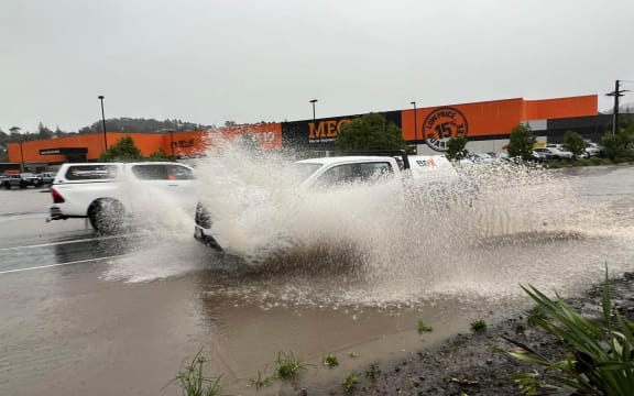 A car driving through floodwaters in Whangārei on 9 May 2023.