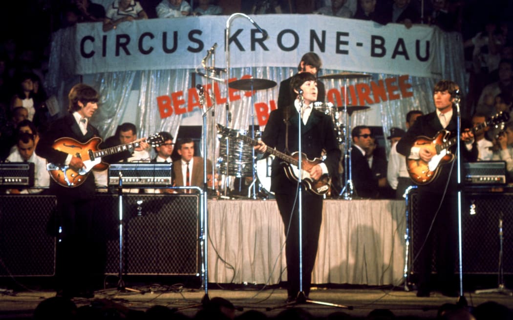 The Beatles (l-r) George Harrison, Paul McCartney, John Lennon and in the background Ringo Starr at the drums, perform in Circus Krone in Munich on the 24th of June in 1966 in front of German audience. Paul McCartney will celebrate his 60th birthday on the 18th of June in 2002. (Photo by Rauchwetter / DPA / dpa Picture-Alliance via AFP)