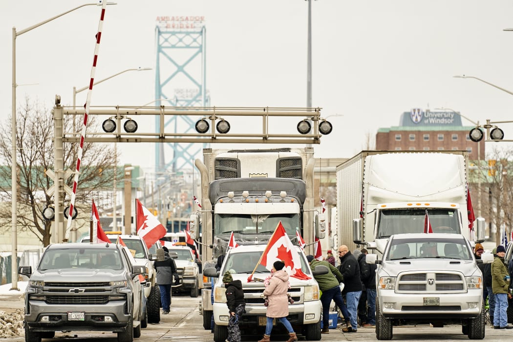 Supporters of the truckers convoy against the Covid-19 vaccine mandate block traffic in the Canada bound lanes of the Ambassador Bridge border crossing, in Windsor, Ontario. 8 February 2022.
