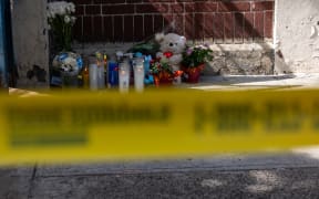 NEW YORK, NEW YORK - SEPTEMBER 21: A small memorial is placed at the door of a Bronx day care center as police and crime scene investigators continue work, after a 1-year-old child died and three other children were injured from alleged exposure to the drug fentanyl last Friday, on September 21, 2023 in New York City. According to court records, authorities have already found a kilo of fentanyl stored on playmats in the center, along with a device to pack the drug into bricks for sale. Two people have been arrested and more arrests are expected.   Spencer Platt/Getty Images/AFP (Photo by SPENCER PLATT / GETTY IMAGES NORTH AMERICA / Getty Images via AFP)