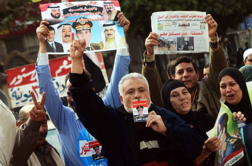 Voters gather outside a polling station in Kafr el-Sheikh.