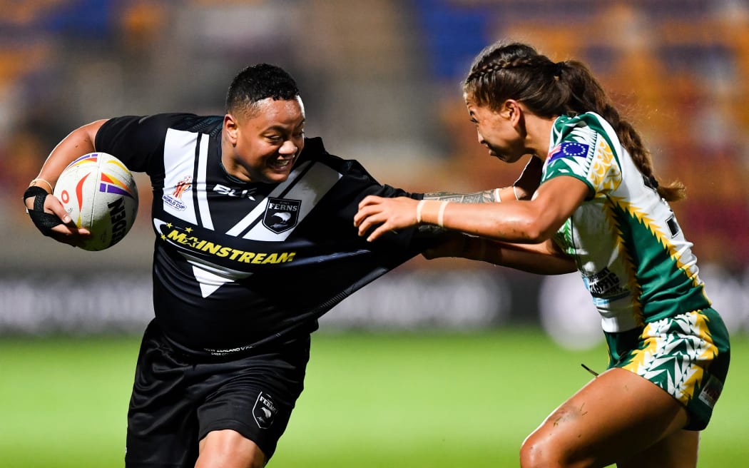 Mele Hufanga of New Zealand hands off Tehinnah-Leal Tatuava of the Cook Islands.