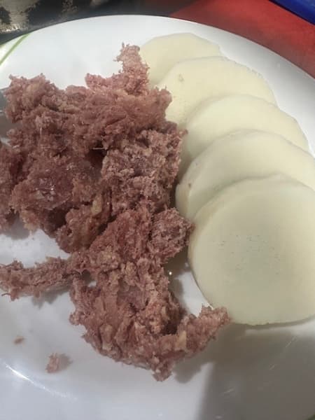 A plate of corned beef and yam.
