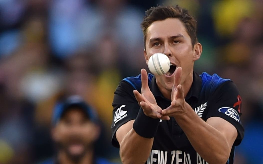 Trent Boult takes a catch off his own bowling to dismiss Australian batsman Aaron Finch.