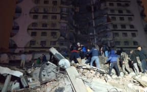 In this video grab from AFP TV taken on February 6, 2023, rescuers search for victims of a 7.8-magnitude earthquake that hit Diyarbakir, in southeastern Turkey, levelling buildings across several cities and causing damages in neighbouring Syria.