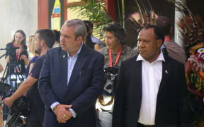 PNG's Sports Minister Justin Tkatchenko waits with the Foreign Minister Rimbink Pato