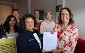 Nik Smith (front left) and her colleagues presented Education Minister Jan Tinetti (front right) with a 5700 signature petition.