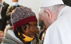 Pope Francis meets a young asylum -seeker at a camp on the Greek island of Lesbos.