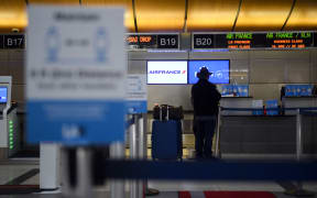 A passenger checks in for a flight at the Air France and KLM counter  at Los Angeles International Airport in January 2021.
