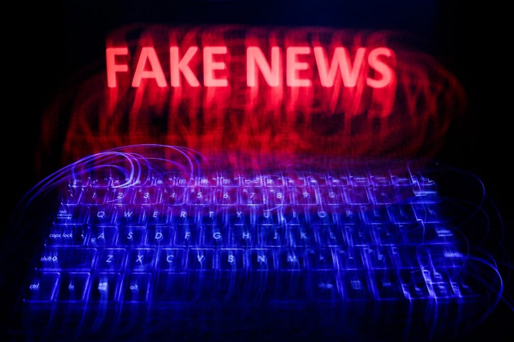 'Fake news' sign is seen displayed on a laptop screen in this long exposure illustration photo taken on June 13, 2020. (Photo by Jakub Porzycki/NurPhoto) (Photo by Jakub Porzycki / NurPhoto / NurPhoto via AFP)