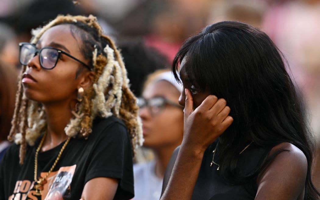 People react as US Vice President Kamala Harris speaks at Howard University in Washington, DC, on November 6, 2024. - Donald Trump won a sweeping victory Wednesday in the US presidential election, defeating Kamala Harris to complete an astonishing political comeback that sent shock waves around the world. (Photo by ANGELA WEISS / AFP)