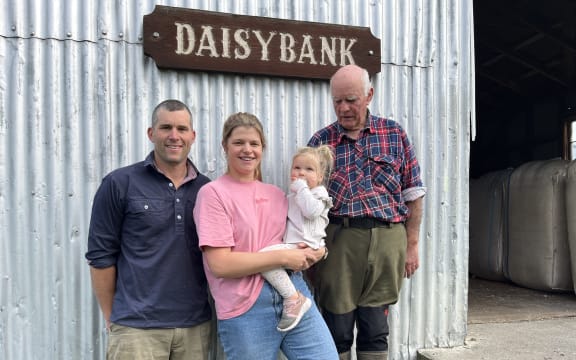 Owen and Emma Harvey, with daughter McKenzie, stand alongside John Harvey, in front of the old woolshed at Daisybank Farm.