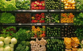 Vegetables on shelves at a supermarket.