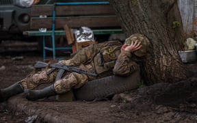 A Ukrainian serviceman takes a rest near the town of Bakhmut, in the Donetsk region on April 29, 2023.