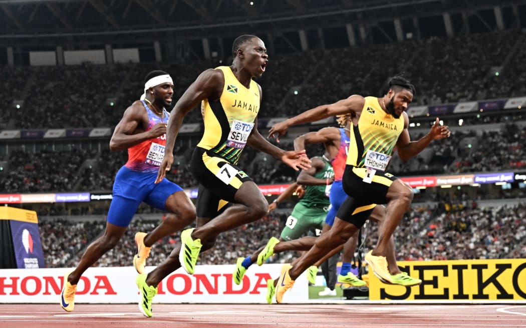 Oblique Seville (L) wins the men's 100m final at the world athletics championships.